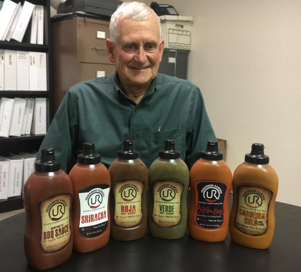 Craig Underwood displays the Sriracha sauce and five other sauces his company is making. Underwood Ranches won a $23.3 million award from a jury this month in a lawsuit involving longtime partner and Sriracha maker Huy Fong Foods.