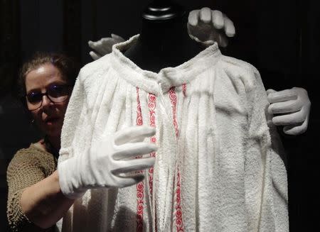 Curators Olivia Lichtscheidl (L) and Michael Wohlfart prepare a bathrobe owned by former Austrian empress Elisabeth for exhibition at Sisi museum in Vienna April 22, 2014. REUTERS/Heinz-Peter Bader