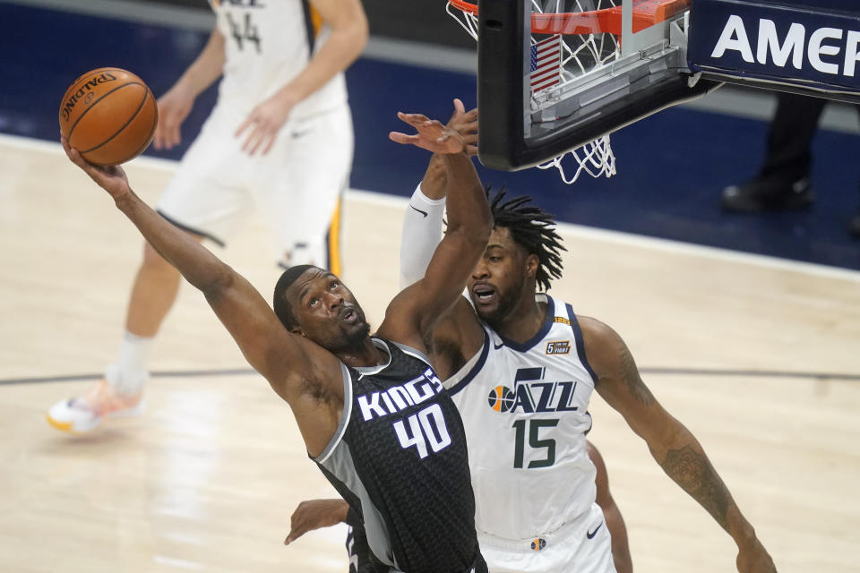 Sacramento Kings forward Harrison Barnes (40) pulls down a rebound as Utah Jazz center Derrick Favors (15) defends in the first half during an NBA basketball game Saturday, April 10, 2021, in Salt Lake City. (AP Photo/Rick Bowmer)