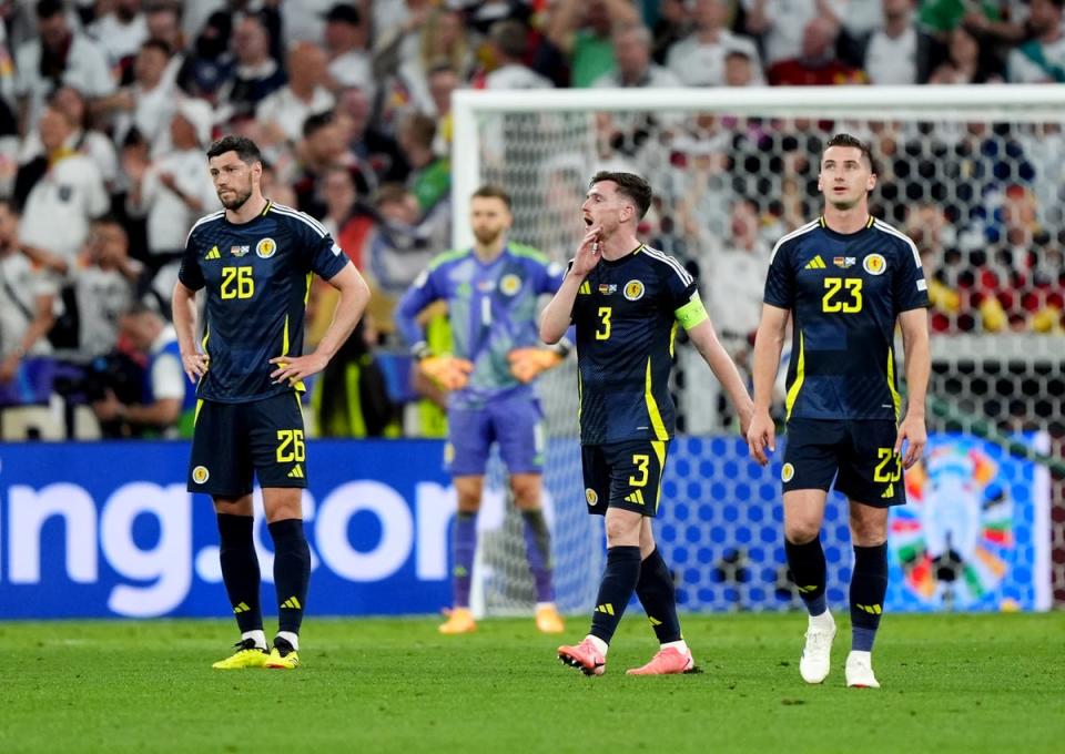 Scott McKenna, Andy Robertson and Kenny McLean appear dejected after Emre Can scores (Andrew Milligan/PA Wire)