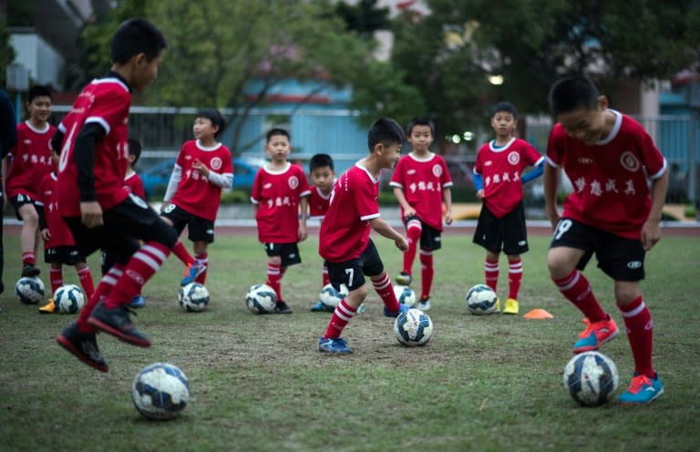 Children attend a football training session in the suburbs of Guangzhou, in southern China's Guangdong province