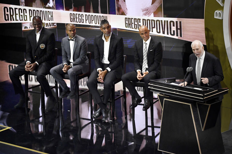 Gregg Popovich speaks during his enshrinement at the Basketball Hall of Fame as presenters David Robinson, Tony Parker, Tim Duncan and Manu Ginobili, from left, listen Saturday, Aug. 12, 2023, in Springfield, Mass. (AP Photo/Jessica Hill)