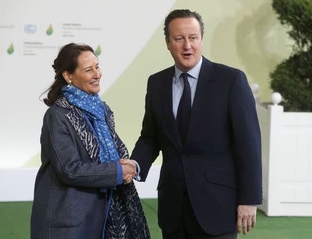 French Ecology Minister Segolene Royal (L) welcomes Britain's Prime Minister David Cameron as he arrives for the opening day of the World Climate Change Conference 2015 (COP21) at Le Bourget, near Paris, France, November 30, 2015. REUTERS/Christian Hartmann