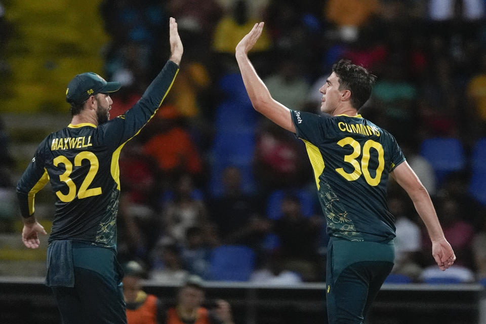 Australia's Pat Cummins, right, is congratulated by teammate Glenn Maxwell after taking the wicket of Bangladesh's Mahmudullah during the ICC Men's T20 World Cup cricket match between Australia and Bangladesh in North Sound, Antigua and Barbuda, Thursday, June 20, 2024. (AP Photo/Lynne Sladky)