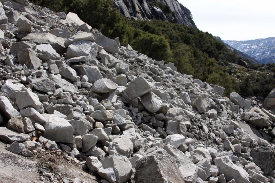 In this photo supplied by Yosemite National Park, a rockfall is seen on Monday, March 31, 2014. Officials at Yosemite National Park say a massive amount of rock has fallen from a cliff, closing a hiking trail. The National Park Service said nobody was hurt on March 31 when approx. 16,000 tons of rock fell 500 feet from a cliff near Hetch Hetchy Reservoir. Officials say the rock crashed down from a cliff east of Wapama Falls. Some 400 feet of the Rancheria Falls Trail were destroyed and park staff says it will remain closed for now. Park officials say hikers can still get to Wampama Falls starting at O'Shaughnessy Dam. (AP Photo/Yosemite National Park)