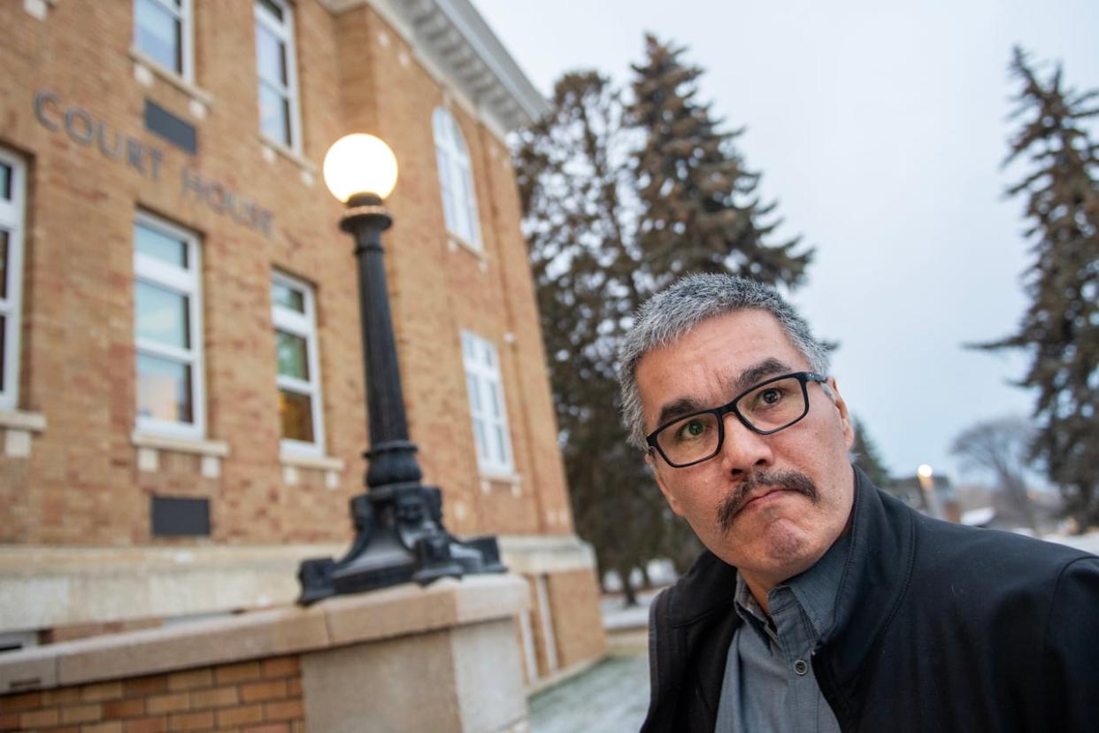 Former RCMP officer Bernie Herman enters court in Prince Albert on Tuesday, the second day of his trial for first-degree murder in the death of Braden Herman. The two are not related. (Liam Richards/The Canadian Press - image credit)