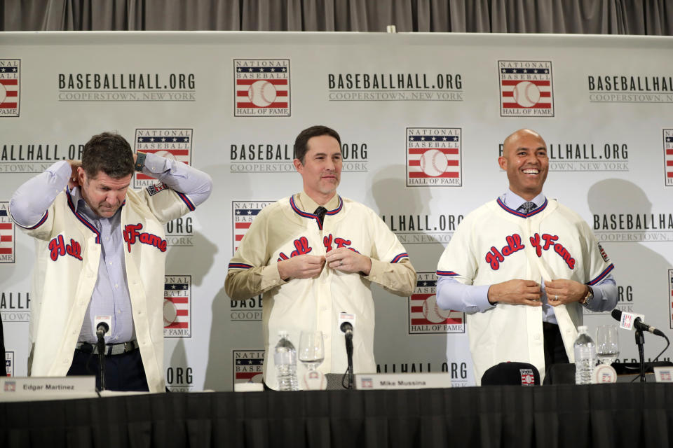 Baseball Hall of Fame inductees Edgar Martinez, left, Mike Mussina, center, and Mariano Rivera, right, put on jerseys during news conference Wednesday, Jan. 23, 2019, in New York. (AP Photo/Frank Franklin II)