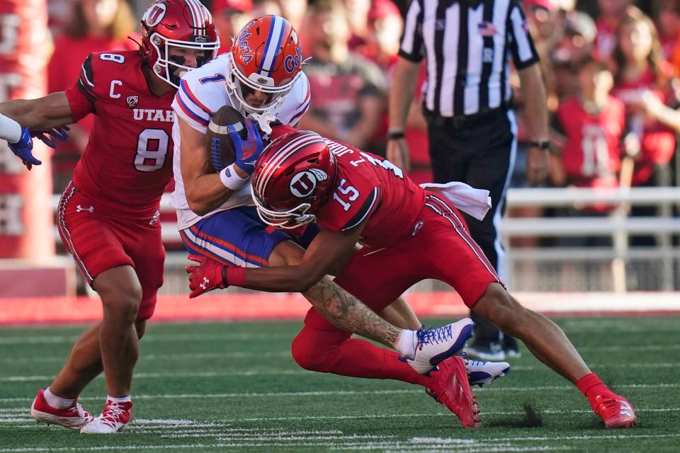 Florida wide receiver Ricky Pearsall (1) is tackled by Utah cornerback Tao Johnson during the first half of Rice-Eccles Stadium in Salt Lake City.