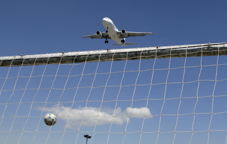 In this Jan. 19, 2013 photo, a plane approaches the Mariscal Sucre airport for landing over the soccer stadium, Liga deportiva Ruminahui, in Quito, Ecuador. Mariscal Sucre airport sat amid cornfields when it was christened in 1960. On Feb. 19, the last flight departs and the airport will close. Its replacement, in an agricultural setting 12 miles (20 kilometers) northeast of the capital, will provide pilots with considerably more margin for error. (AP Photo/Dolores Ochoa)