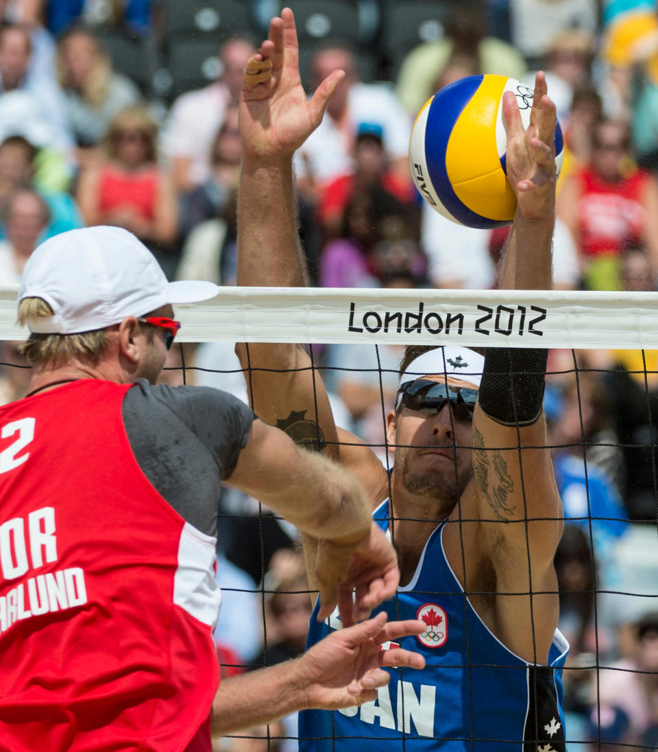 Canada's Martin Reader misses a block during preliminary beach volleyball action against Tarjei Viken Skarlund and Martin Spinnangr at the 2012 London Olympics, on July 30, 2012. Reader and his partner Joshua Binstock lost two sets to none. COC Photo: Jason Ransom