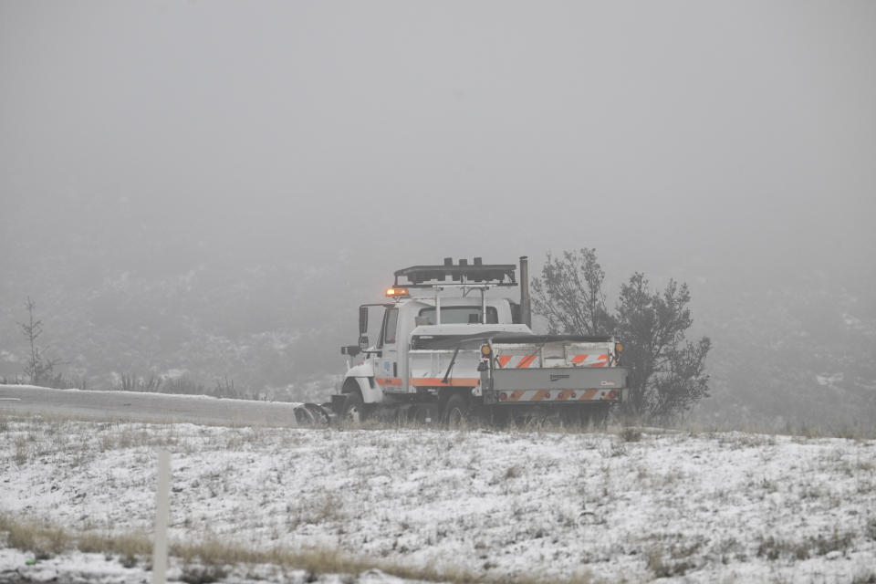 A Caltrans snow plow clears snow from the I-8 at the Laguna Summit in Wednesday, Feb. 7, 2024, in eastern San Diego County, Calif. According to the National Weather Service snow level is down to 4500 feet in the San Diego County mountains. (AP Photo/Denis Poroy)