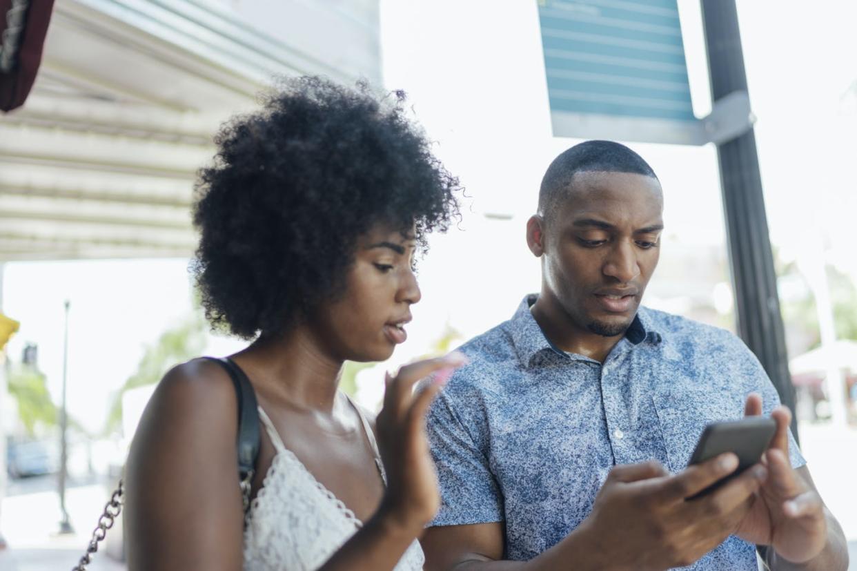 <span class="caption">Social media is flush with advice urging non-menstruating people to use period tracking apps in order to trip up the apps' algorithms.</span> <span class="attribution"><a class="link " href="https://www.gettyimages.com/detail/photo/florida-miami-beach-young-couple-using-cell-phone-royalty-free-image/1125575075" rel="nofollow noopener" target="_blank" data-ylk="slk:Westend61 via Getty Images;elm:context_link;itc:0;sec:content-canvas">Westend61 via Getty Images</a></span>