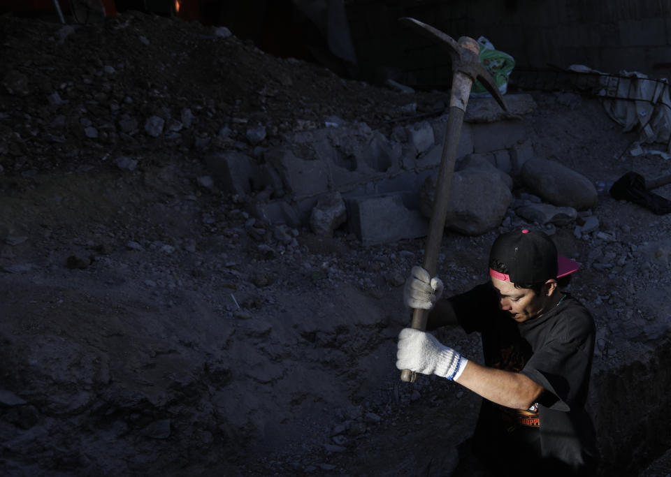 In this Dec. 5, 2018 photo, Honduran migrant Jose Elino, 23, works as a day laborer at a construction site in Tijuana, Mexico. Facing the possibility of a months-long wait in Tijuana before even having an opportunity to request asylum in the United States, members of the migrant caravans that have arrived in Tijuana are looking for work. (AP Photo/Rebecca Blackwell)