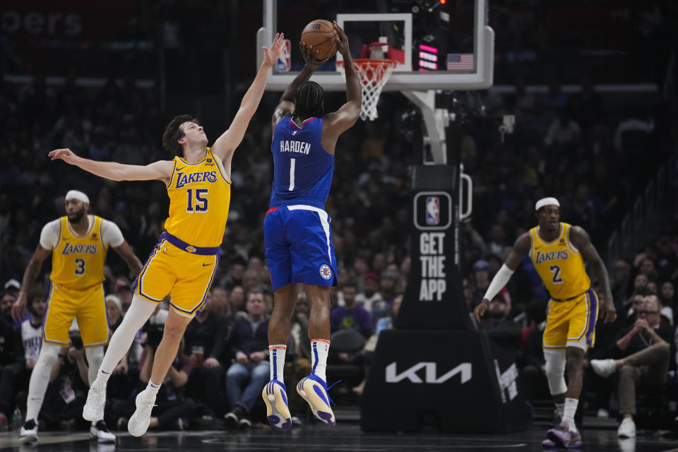 Los Angeles Clippers guard James Harden (1) shoots against Los Angeles Lakers guard Austin Reaves (15) during the first half of an NBA basketball game in Los Angeles, Tuesday, Jan. 23, 2024. (AP Photo/Ashley Landis)