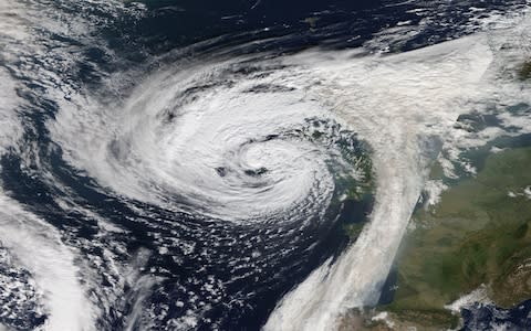 NASA MODIS Terra satellite shows the remnants of Hurricane Ophelia, which slammed into Ireland and western parts of Britain - Credit: Atlas Photo Archive/NASA