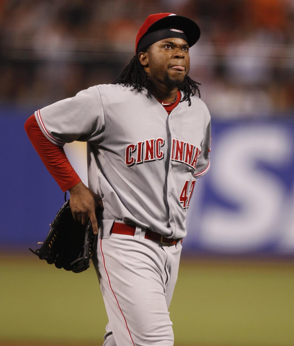 In an early blow, ace Johnny Cueto suffered an oblique strain after throwing just eight pitches in Game 1.  The Enquirer/Gary Landers
Reds-Giants.  Cincinnati Reds' pitcher Johnny Cueto bites his tongue as he leaves the field after an injury during the first inning of their first division series championship game against the San Francisco Giants at AT&T Park in San Francisco, California Saturday October 6, 2012. The Enquirer/Gary Landers