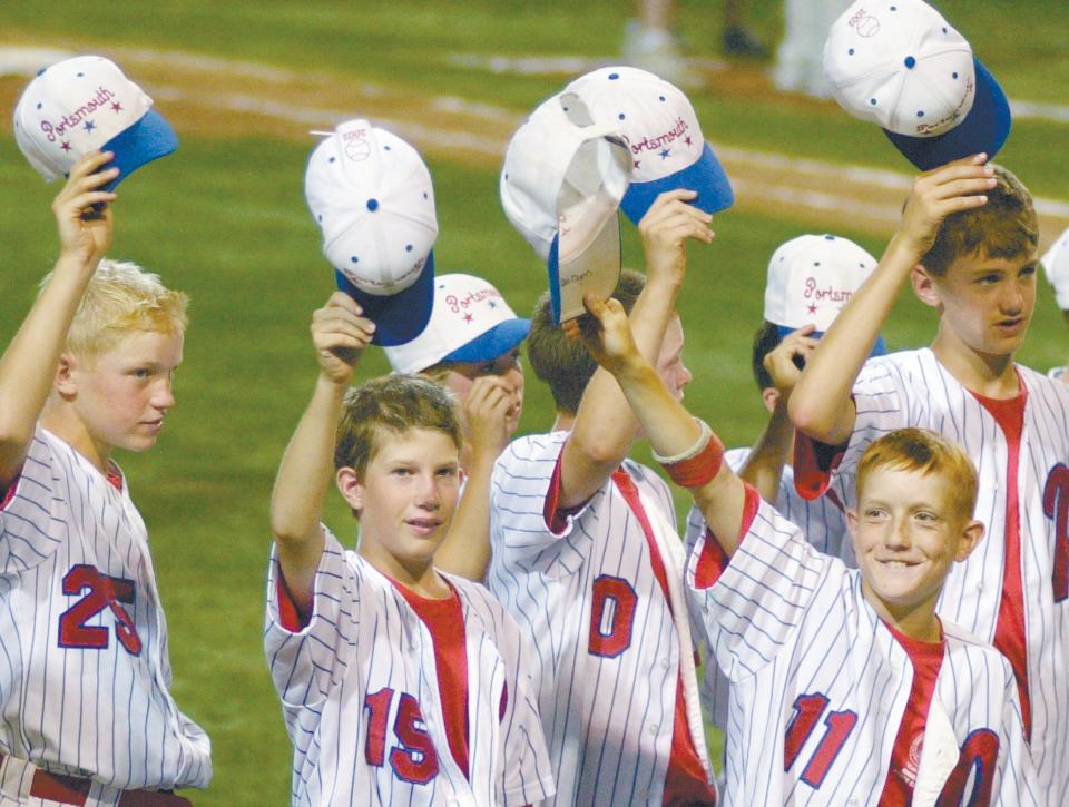 Members of the Portsmouth Little League Majors all-star team tip their caps to the crowd after losing in the New England regional final in 2002.