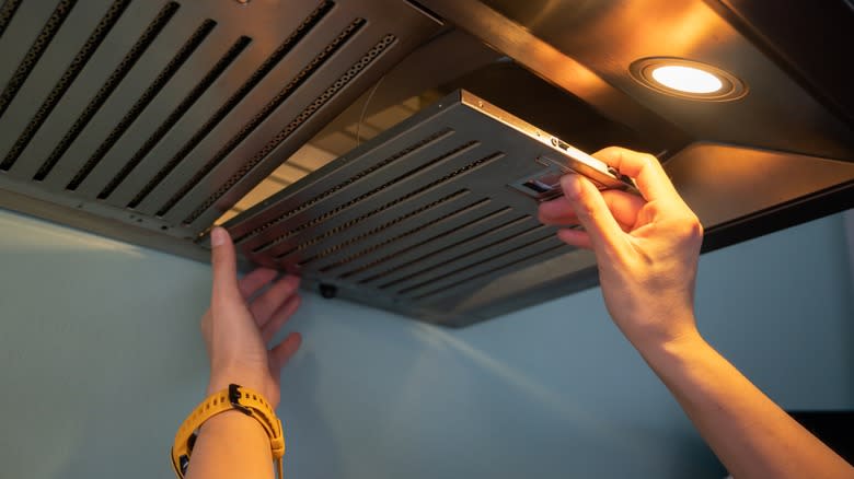 person working with range hood
