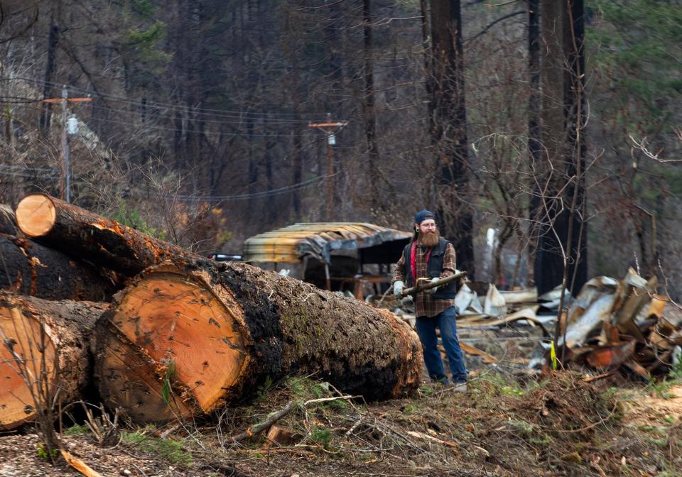 Geff Gravitt II works to clear a property along Highway 126 after the Holiday Farm Fire burned through the area last year. A crew co-owned by his father, Geff Gravitt, has cleared and done construction on more than 30 properties as homeowners turn their attention toward rebuilding along the McKenzie River Valley.