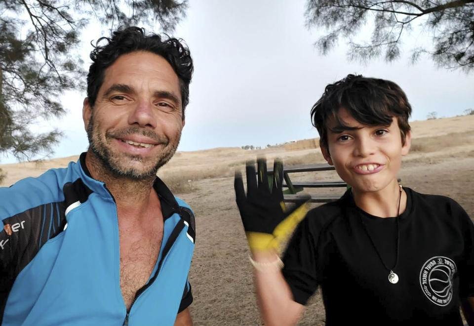 In this image provided courtesy of the family by Abbey Onn, Ofer Kalderon, left, and his son Erez are pictured in this family photo. Abbey Onn lost her aunt and a young cousin when Hamas militants rampaged through Kibbutz Nir Oz on Oct. 7. Now Onn is worried about what will happen to three other family members taken hostage that day, as Israel pounds Gaza City in a bid to end Hamas’ control of the Gaza Strip. She wants the world to remember that Ofer Kalderon, 50, and his children Sahar, 16, and Erez, 12, are caught in the cross-fire. (Courtesy of family via AP)