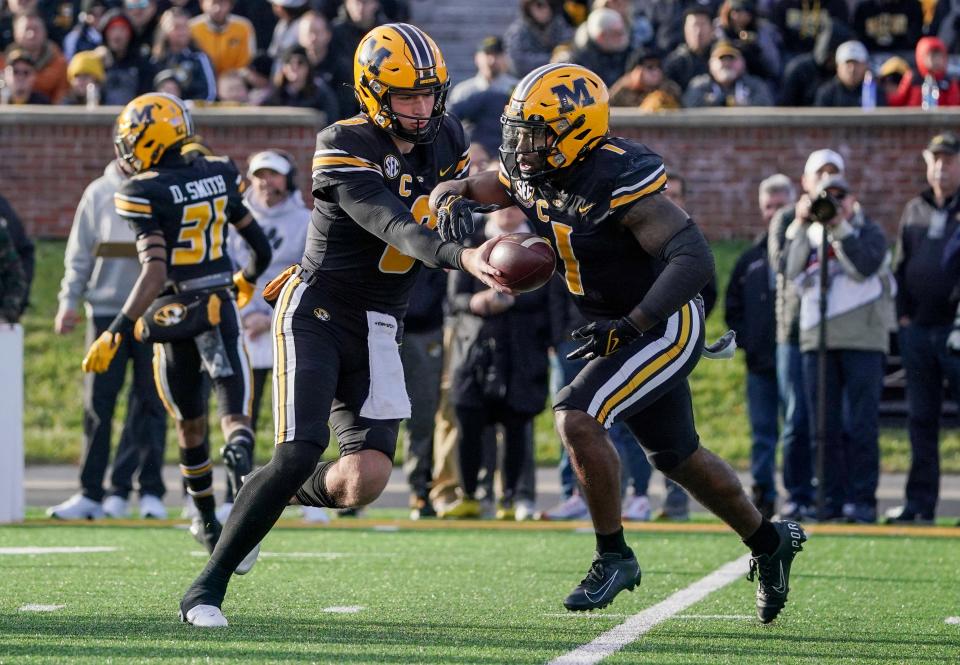 Nov 13, 2021; Columbia, Missouri, USA; Missouri Tigers quarterback Connor Bazelak (8) hands off to running back Tyler Badie (1) against the South Carolina Gamecocks during the first half at Faurot Field at Memorial Stadium. Mandatory Credit: Denny Medley-USA TODAY Sports
