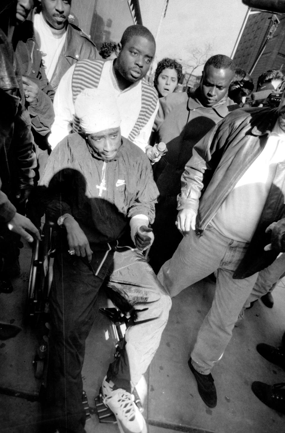 Tupac est reconnu coupable d’un "acte de violence brutale contre une femme sans défense" dans l’affaire Ayanna Jackson. Le 1er décembre 1994, il se rend au tribunal de New York dans un fauteuil roulant, le corps couvert de bandages. Il est condamné à un an et demi d’emprisonnement et est incarcéré au pénitencier de Dannemora, dans l’État de New York, alors qu’il clame son innocence. Derrière les barreaux, l’interprète de <em>Changes </em>épouse Keisha Morris. Il a rencontré cette étudiante en droit âgée de 20 ans dans un club new-yorkais quelques mois plus tôt. Particulièrement touché par la présence de la jeune femme à son chevet après la fusillade survenue à Times Square, il aurait également mis un terme à sa liaison avec Madonna avant cette union, célébrée le 4 avril 1995 au pénitencier. (<em>Photo by W. A. Funches Jr./New York Post/Photo Archives, LLC via Getty Images</em>)