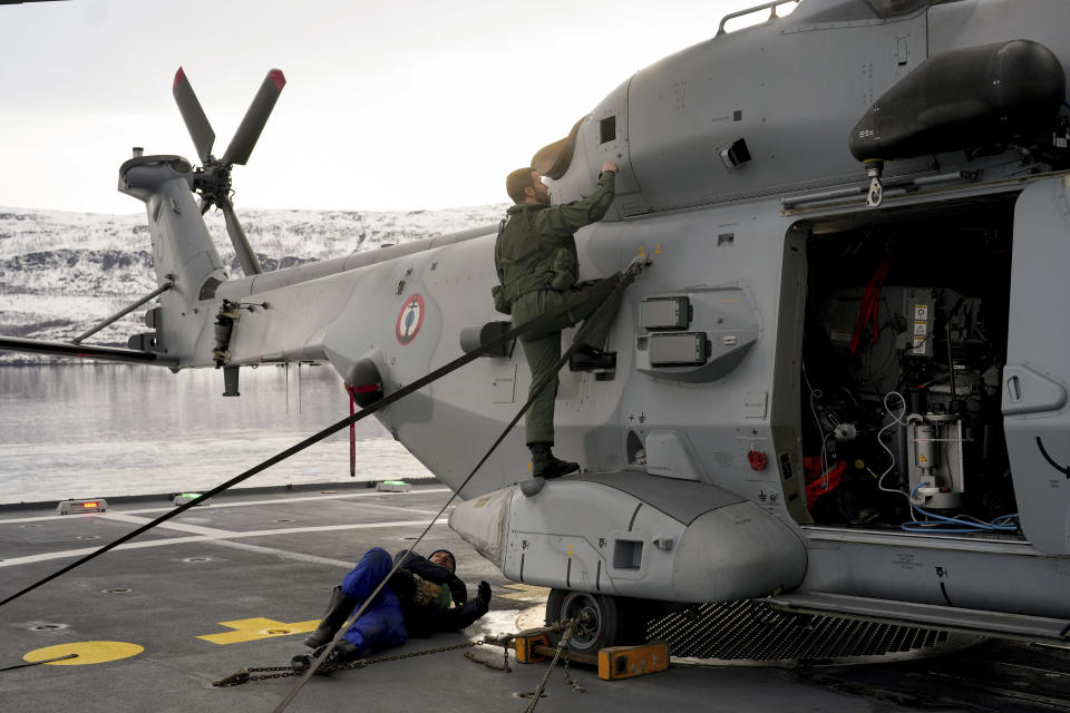 French helicopter pilot, Lt. Olivier checks his helicopter prior a take off aboard the French navy frigate Normandie keep watch as the vessel patrols in a Norwegian fjord, north of the Arctic circle, for a reconnaissance patrol, Wednesday March 6, 2024. The French frigate is part of a NATO force conducting exercises in the seas, north of Norway, codenamed Steadfast Defender, which are the largest conducted by the 31 nation military alliance since the cold war.(AP Photo/Thibault Camus)