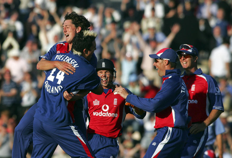 England bowler Jon Lewis is mobbed by team-mates after taking the wicket of Australia's Ricky Ponting in a Twenty20 match at the Rose Bowl Stadium in Southampton 13 June 2005. 