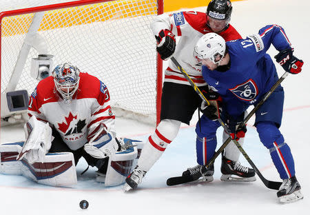 Ice Hockey - 2016 IIHF World Championship - Group B - Canada v France - St. Petersburg, Russia - 16/5/16 - Calvin Pickard of Canada in action with Valentin Claireaux of France. REUTERS/Maxim Zmeyev