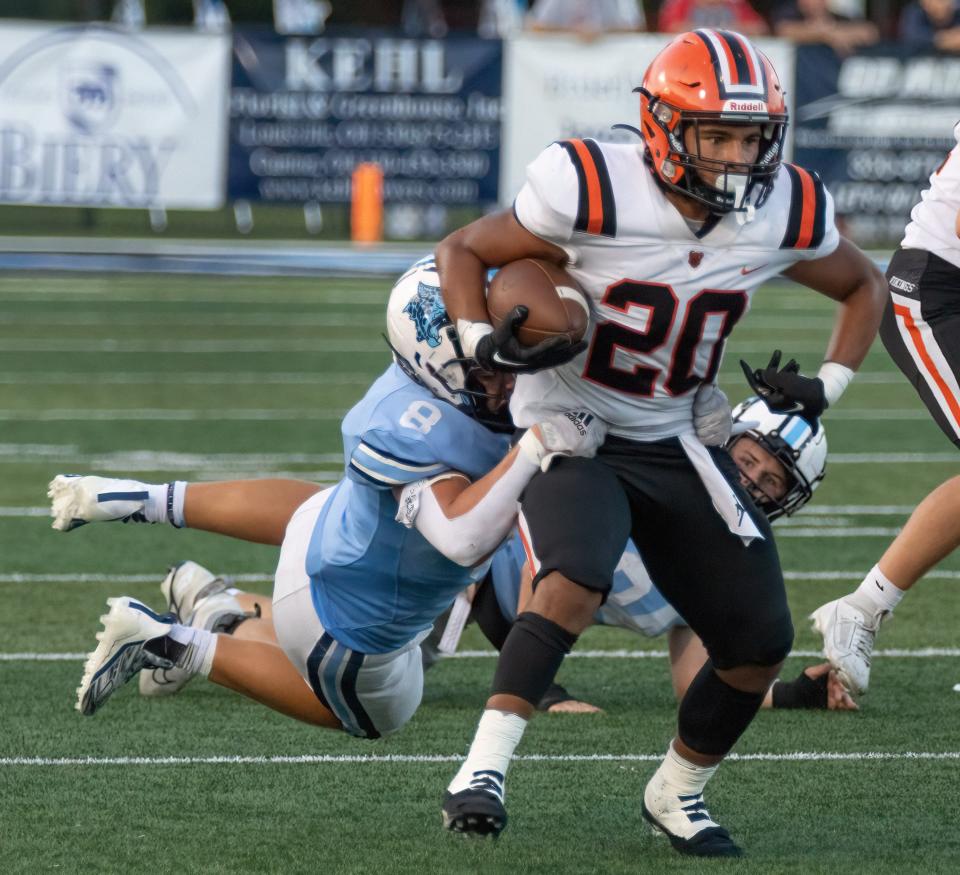 Louisville’s Cam Dougherty dives to tackle Hoover’s Kyler Miraglia during the first quarter Friday, Sept. 8, 2023.