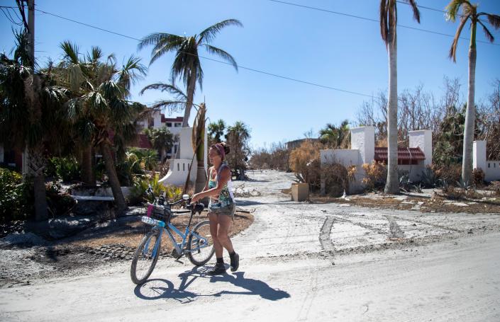 Bridgit Stone-Budd waits to meet her daughter on Sanibel Island on Friday, Oct. 7, 2022. Budd, who owns The Pecking Order restaurant, stayed on the island during the storm and has been checking on homes for her friends.