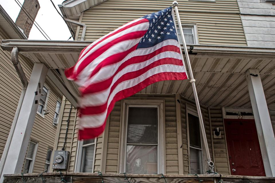 A US flag blows in the wind in front of a house on N Chapel Street in Newark, Sun., Jan. 29, 2023.