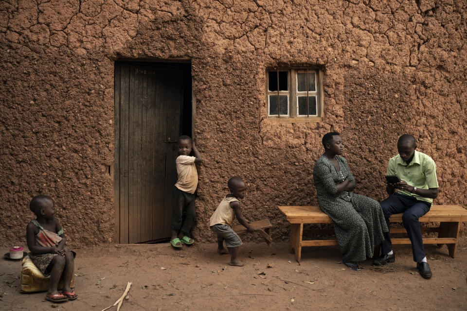 In this Sept. 10, 2019 photo, Janvier Ngabonziza, right, interviews Lyiza Uwimbabazi about her sister who passed away recently during a "verbal autopsy" in Rwamagana, Rwanda. To date, about 2,700 verbal autopsies have been done, in nine small areas. That's not enough data to provide a good look at national death trends, but the government is planning to scale up the work to collect enough information to provide a representative sample. (AP Photo/Felipe Dana)