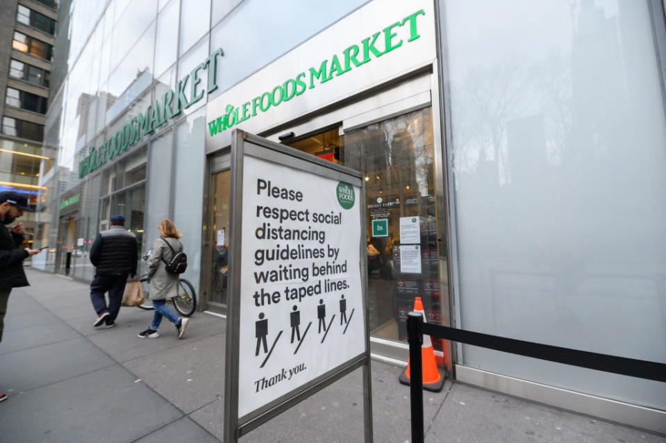 A sign outside a Whole Foods Market store in New York asks customers to respect their distancing guidelines. Source: Getty