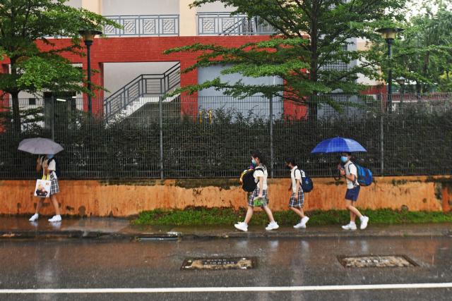 Pupils leave their school after class in Singapore.