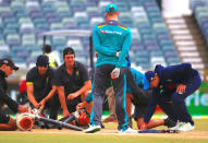 Cricket - Ashes test match - Australia v England - WACA Ground, Perth, Australia, December 18, 2017. England's captain Joe Root touches the pitch as groundsmen use blowers in an attempt to dry it out before the start of the fifth day of the third Ashes cricket test match. REUTERS/David Gray