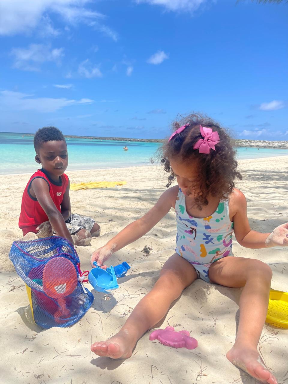 Jewel Grant's children, Jackson and Simone, play in the sand.