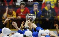 Young Sweden fans watch as Finland players celebrate with the trophy after they defeated Sweden in overtime of their IIHF World Junior Championship gold medal ice hockey game in Malmo, Sweden, January 5, 2014. REUTERS/Alexander Demianchuk (SWEDEN - Tags: SPORT ICE HOCKEY)