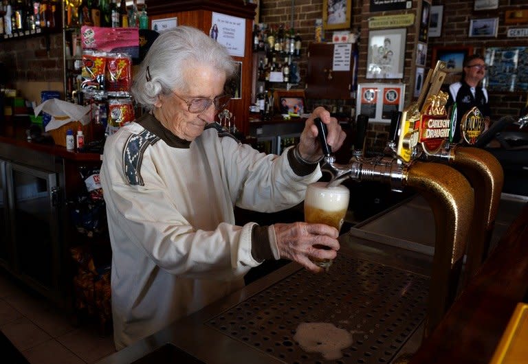 Sydney's oldest barmaid Lil Miles pulls a beer at her family's Bells Hotel in Woolloomooloo, Sydney, on May 14, 2013. Miles has seen her city transform, witnessed the fall and rise of her neighbourhood and suffered family tragedy, but at the age of 91 Sydney's oldest barmaid has no plans to retire