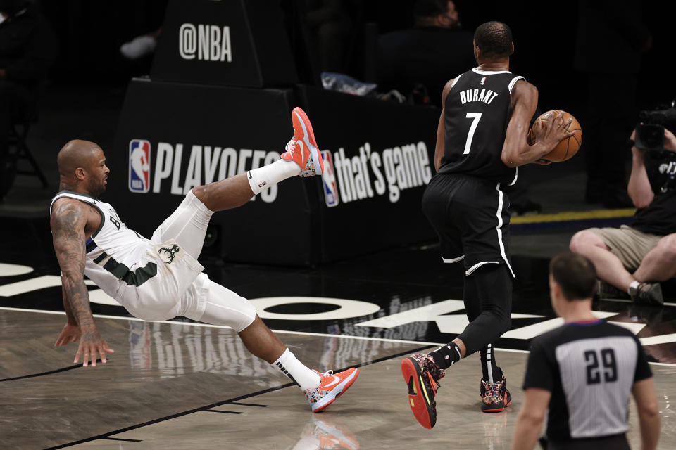 Brooklyn Nets forward Kevin Durant (7) shakes off Milwaukee Bucks forward P.J. Tucker during the first half of Game 1 of an NBA basketball second-round playoff series Saturday, June 5, 2021, in New York. (AP Photo/Adam Hunger)