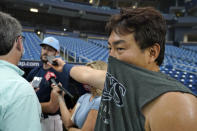 Tampa Bay Rays first baseman Ji-Man Choi pretends to be reporter interviewing pitcher Ryan Thompson before a baseball game against the Washington Nationals Tuesday, June 8, 2021, in St. Petersburg, Fla. Reporters were allowed on the field for the first time since 2019 after coronavirus restrictions were eased. (AP Photo/Chris O'Meara)