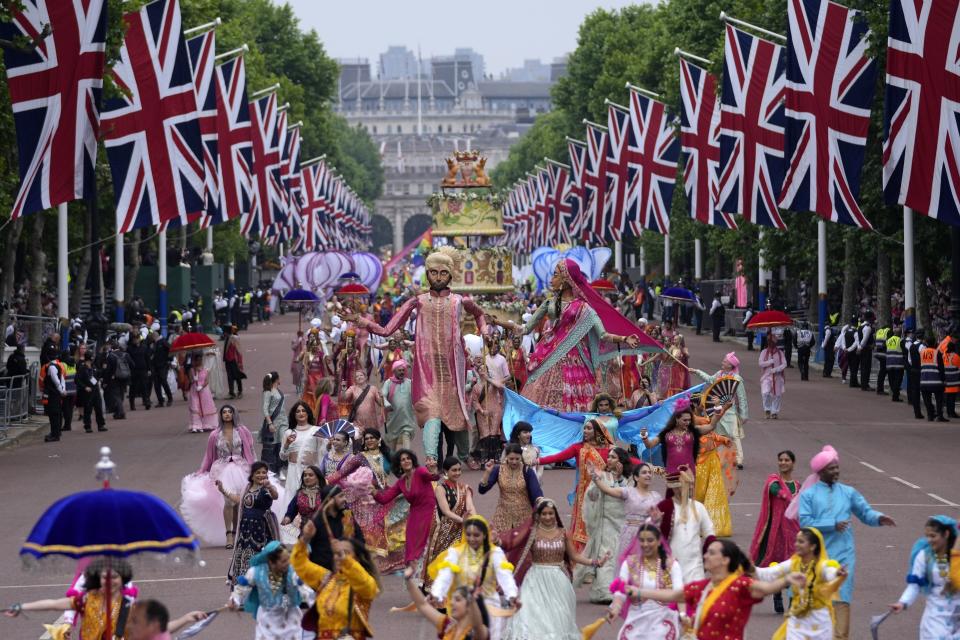 People parade during the Platinum Jubilee Pageant outside Buckingham Palace in London, Sunday, June 5, 2022, on the last of four days of celebrations to mark the Platinum Jubilee. (AP Photo/Frank Augstein, Pool)