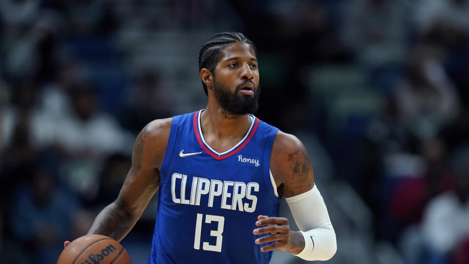 Los Angeles Clippers guard Paul George (13) moves the ball down court in the second half of an NBA basketball game against the New Orleans Pelicans in New Orleans, Friday, Nov. 19, 2021. The Pelicans won 94-81. (AP Photo/Gerald Herbert)