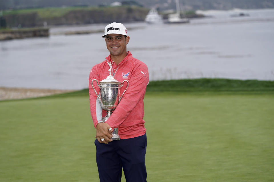 Gary Woodland posses with the trophy after winning the U.S. Open Championship golf tournament Sunday, June 16, 2019, in Pebble Beach, Calif. (AP Photo/David J. Phillip)