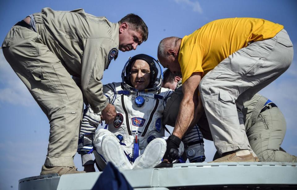 Ground personnel help David Saint-Jacques of the Canadian Space Agency get out of the Soyuz MS-11 capsule shortly after landing in a remote area outside Zhezkazgan, Kazakhstan, on June 25, 2019.