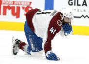 Colorado Avalanche's Pierre-Edouard Bellemare holds his mouth after getting hit by the puck during the second period of the team's NHL hockey game against the Arizona Coyotes on Saturday, Feb. 27, 2021, in Glendale, Ariz. (AP Photo/Darryl Webb)