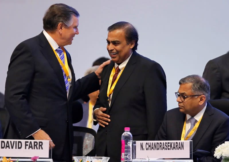 FILE PHOTO: David Farr, CEO of Emerson Electric speaks with Mukesh Ambani, Chairman of Reliance Industries, as Tata Sons Chairman Natarajan Chandrasekaran looks on as they attend the Vibrant Gujarat Global Summit in Gandhinagar