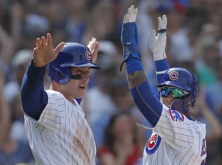 Aug 10, 2018; Chicago, IL, USA; Chicago Cubs first baseman Anthony Rizzo (44) and second baseman Javier Baez (9) celebrate after scoring two runs against the Washington Nationals during the sixth inning at Wrigley Field. Mandatory Credit: Jim Young-USA TODAY Sports