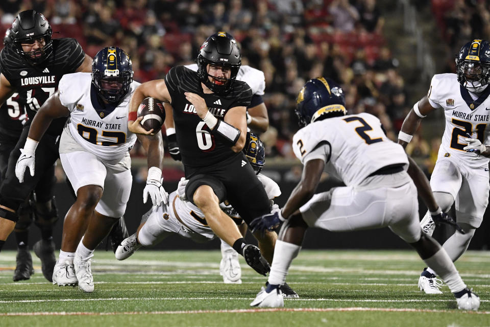 Louisville quarterback Evan Conley (6) attempts to get away from Murray State defenders, including Zayteak McGhee (2), during the second half of an NCAA college football game in Louisville, Ky., Thursday, Sept. 7, 2023. (AP Photo/Timothy D. Easley)