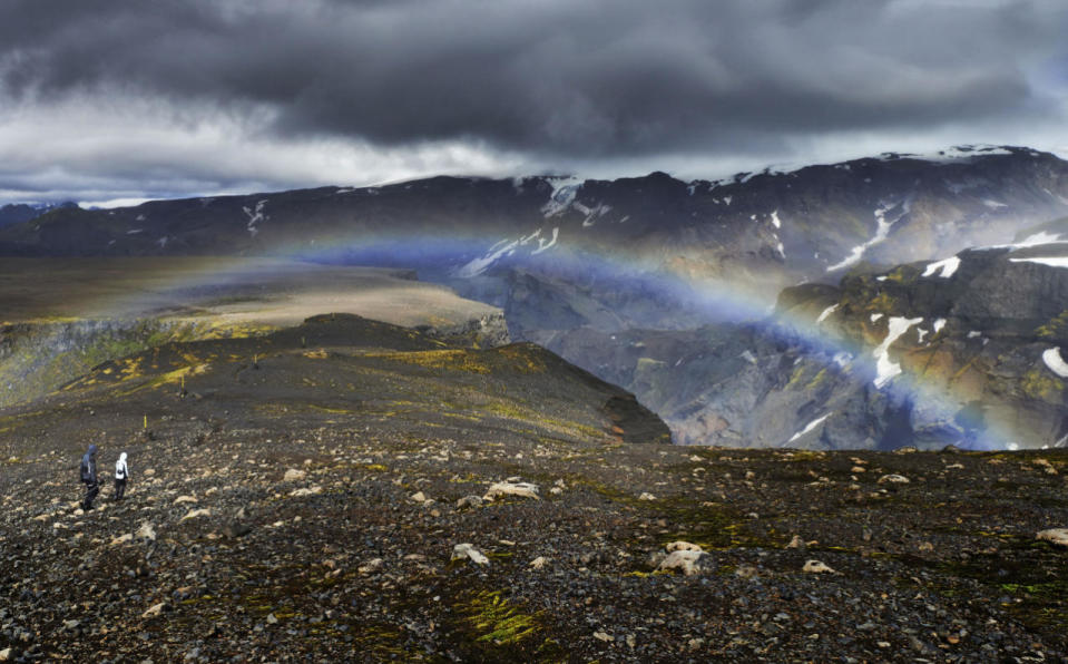 A landscape view of a rainbow appearing near a waterfall. (Michael Fersch/Caters News Agency)